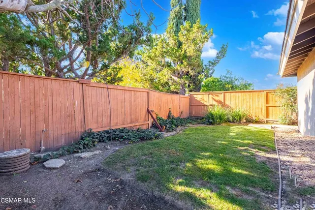 a view of backyard with plants and outdoor seating