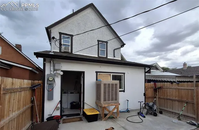 a view of house that has wooden fence