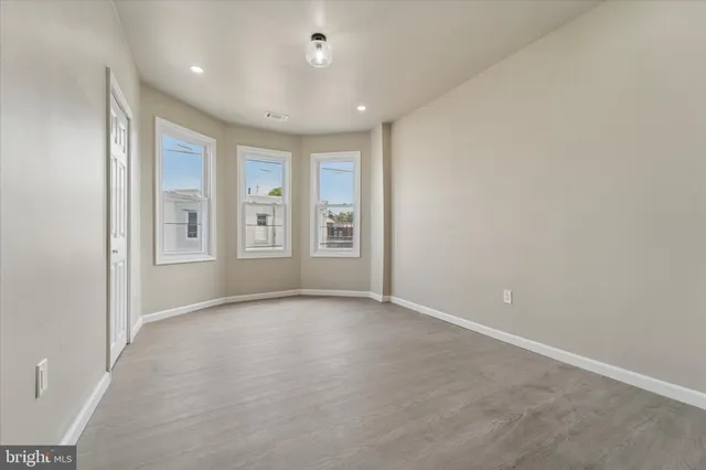 an empty room with windows and closet