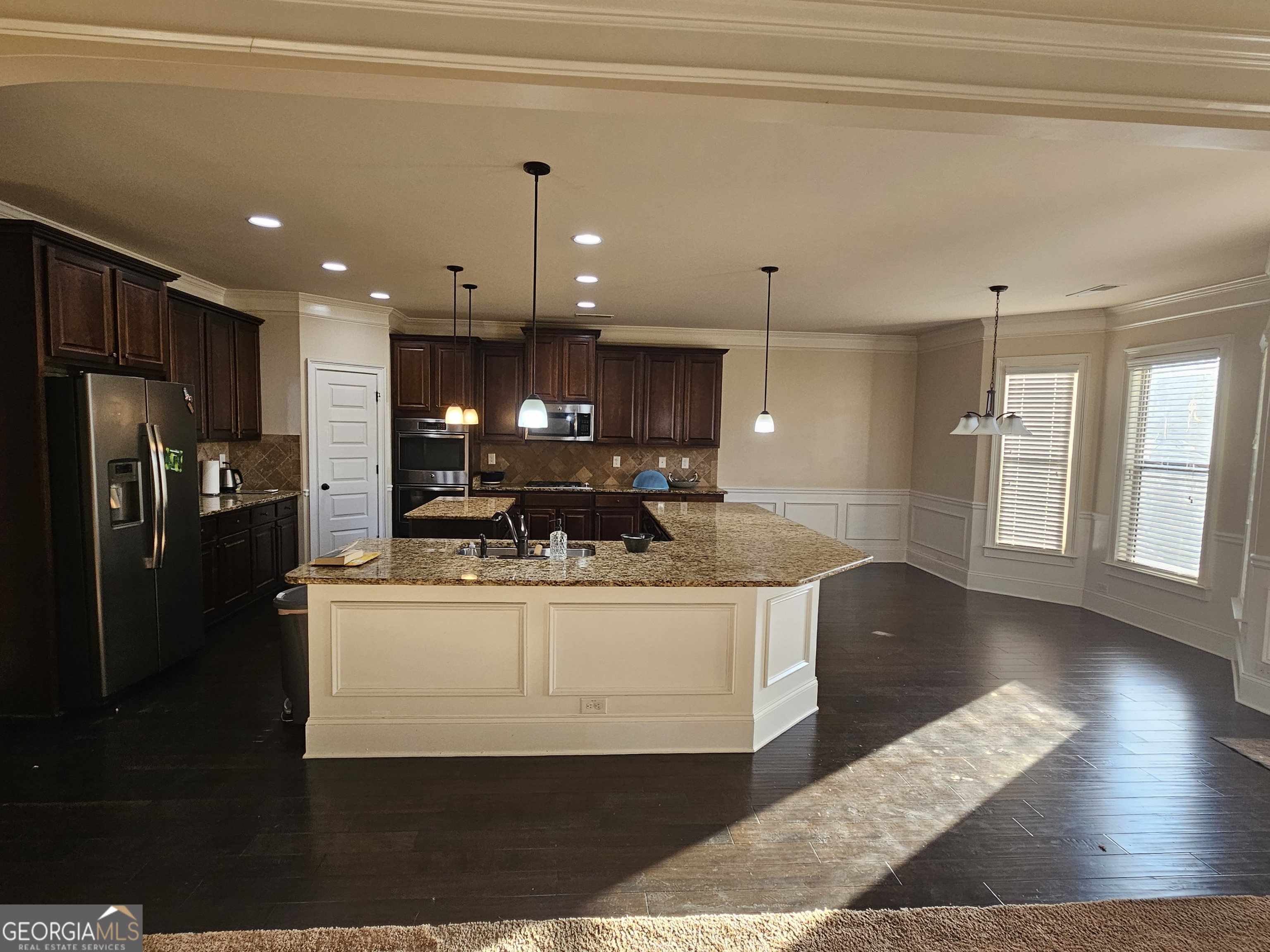 3906 Rosebay Way Southwest Conyers, GA 30094 - Photo 16 of 38 a view of kitchen with refrigerator stove and wooden floor