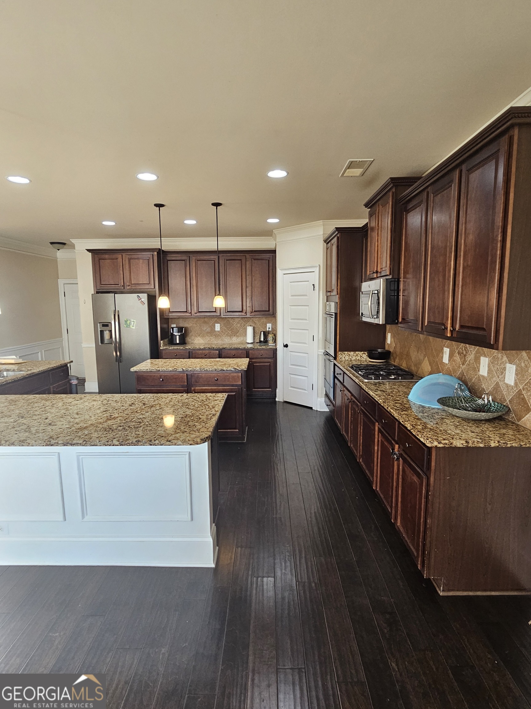 3906 Rosebay Way Southwest Conyers, GA 30094 - Photo 18 of 38 a kitchen with stainless steel appliances granite countertop a stove a sink and a refrigerator