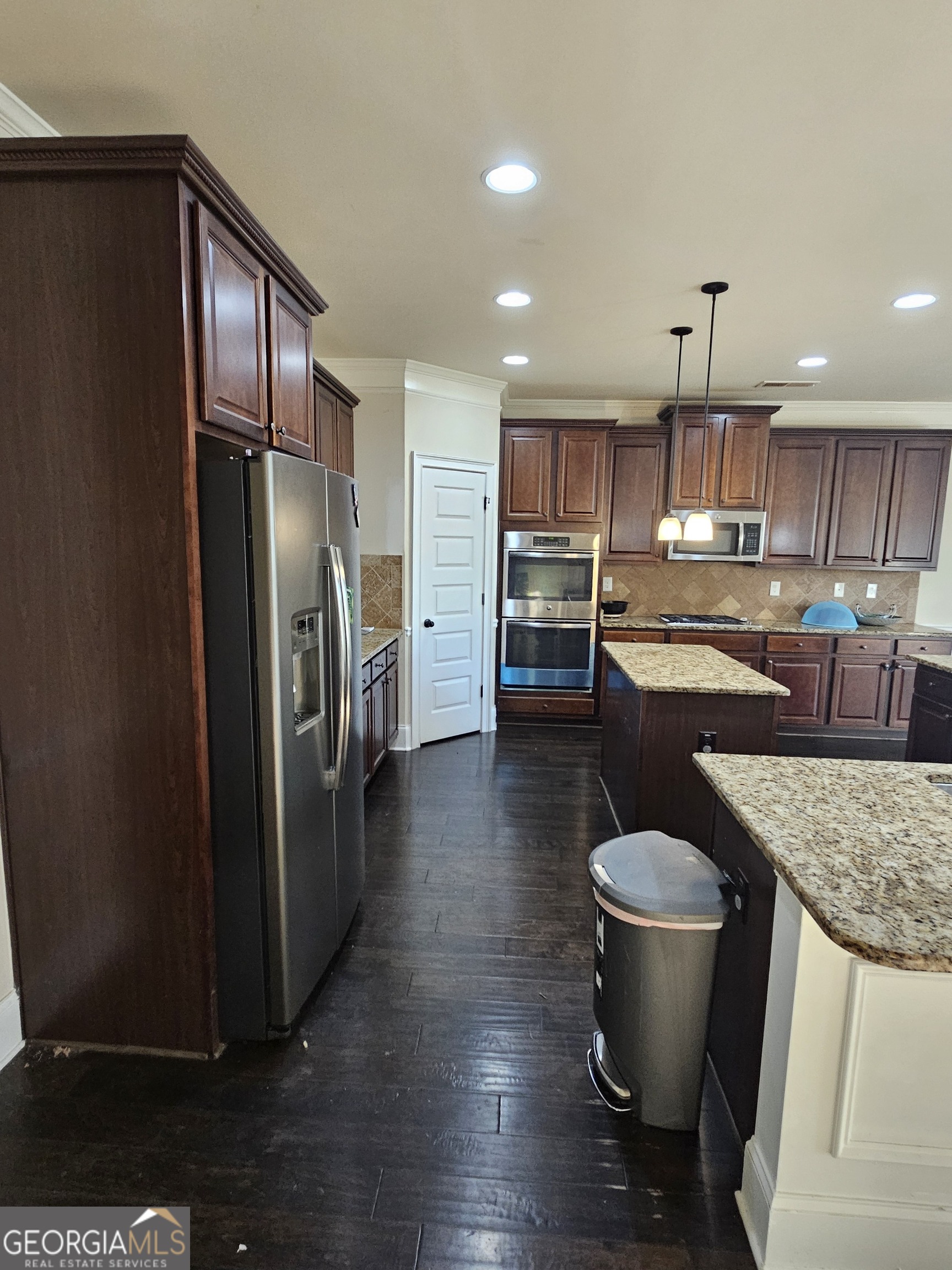 3906 Rosebay Way Southwest Conyers, GA 30094 - Photo 19 of 38 a kitchen with stainless steel appliances granite countertop a refrigerator a sink a stove and a wooden cabinets