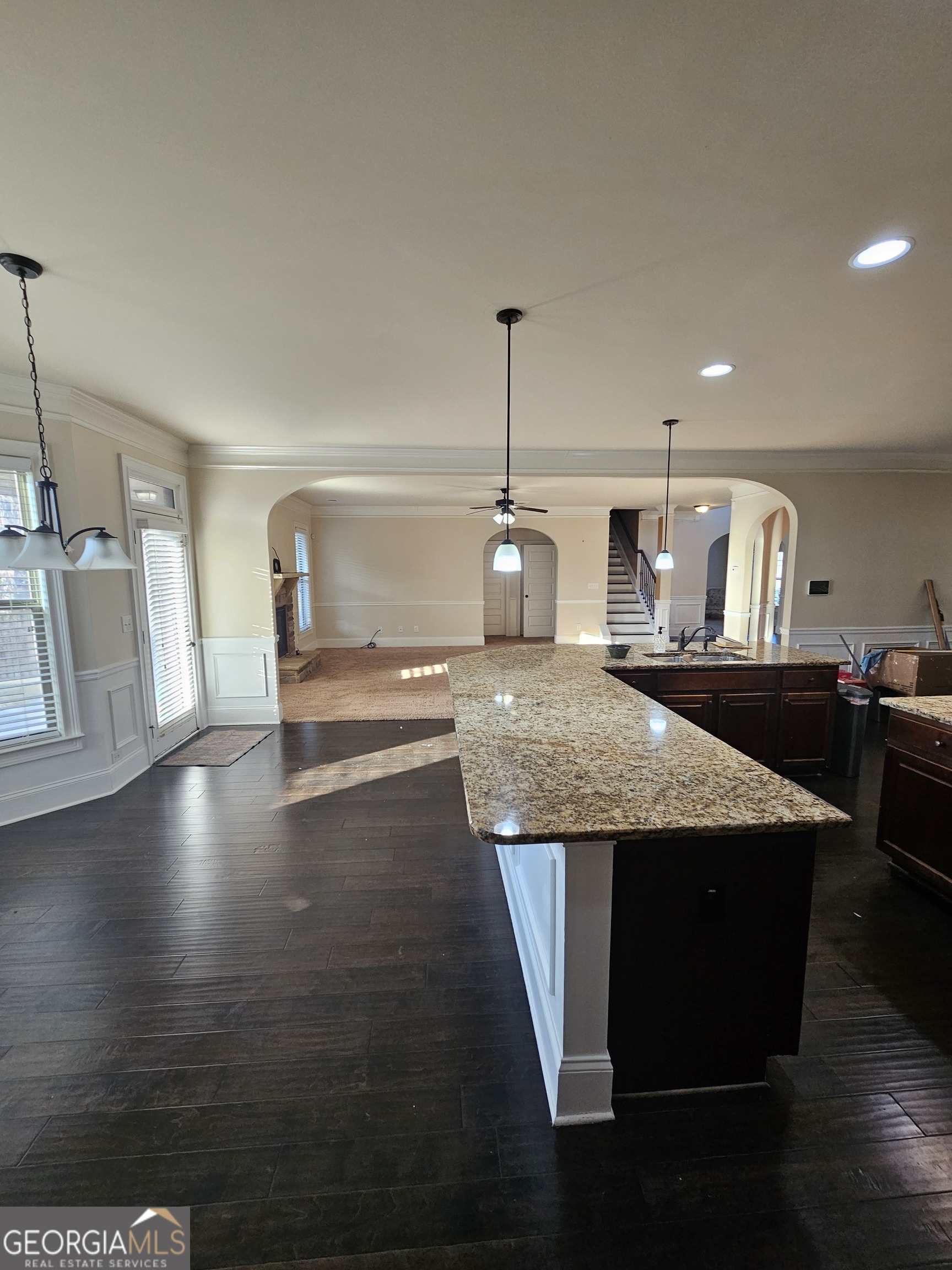 3906 Rosebay Way Southwest Conyers, GA 30094 - Photo 20 of 38 a view of a room with wooden floor staircase and kitchen view