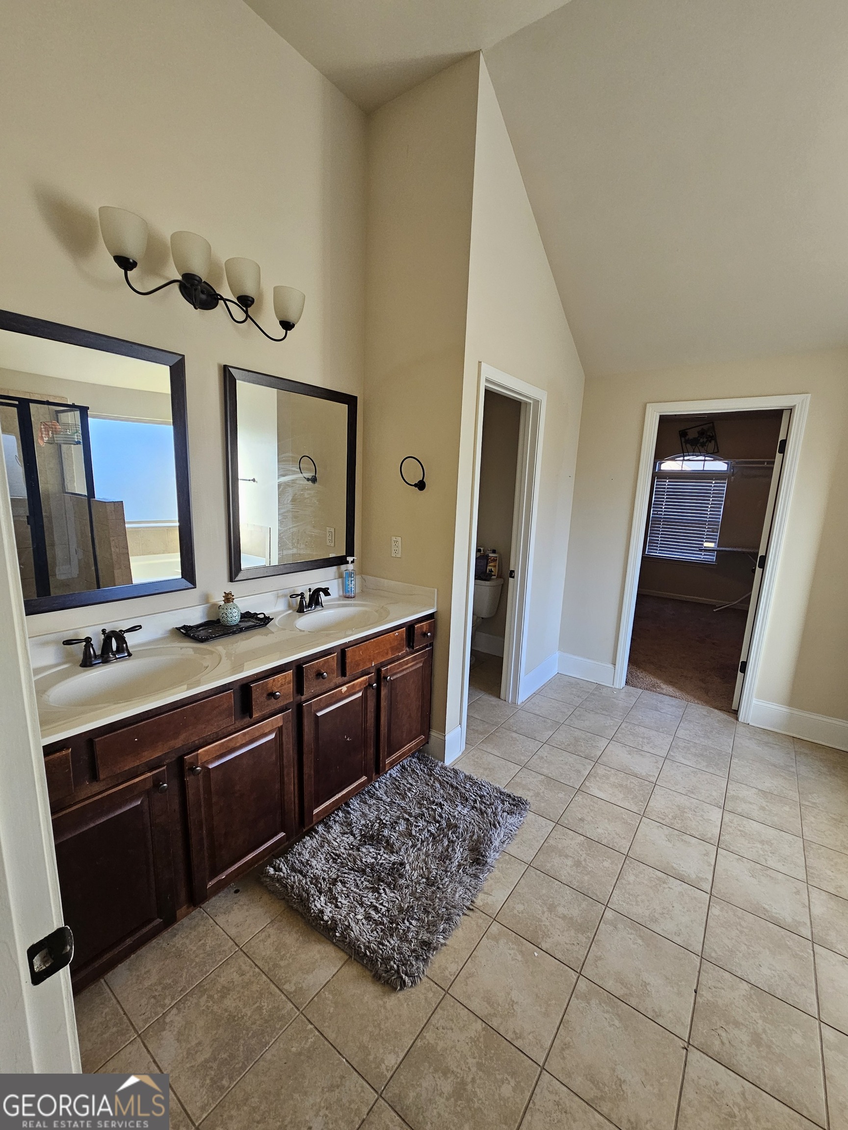 3906 Rosebay Way Southwest Conyers, GA 30094 - Photo 26 of 38 a large bathroom with a sink and a mirror