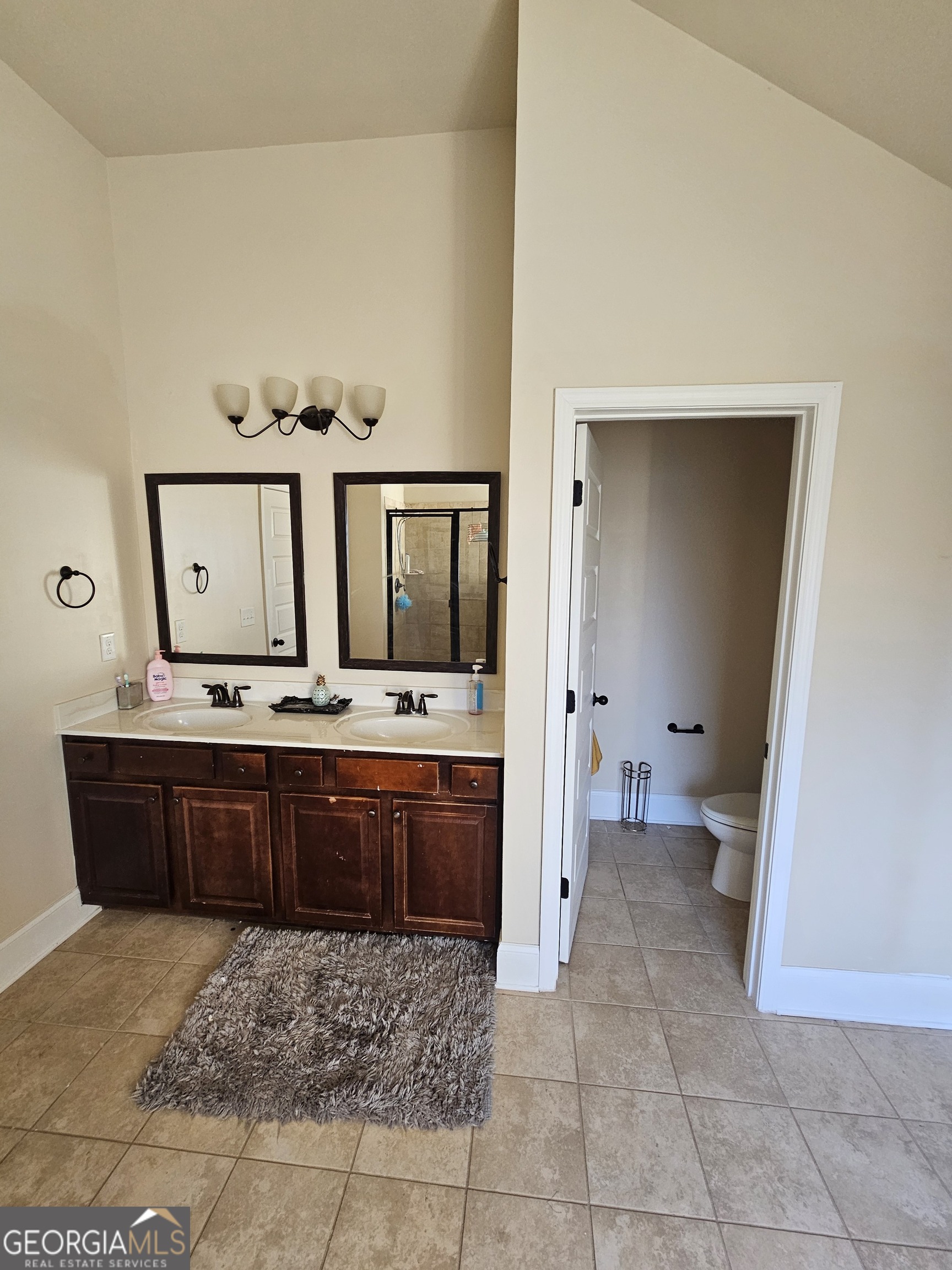 3906 Rosebay Way Southwest Conyers, GA 30094 - Photo 27 of 38 a large bathroom with a vanity a sink a mirror and a bathtub