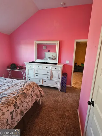 a bedroom with a bed and a mirror