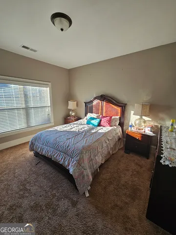 a bedroom with a bed and window