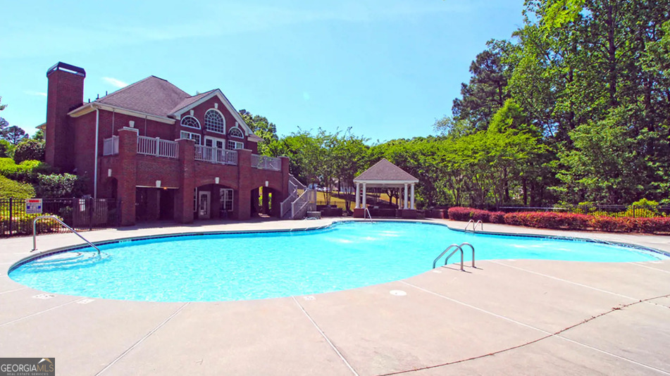 3906 Rosebay Way Southwest Conyers, GA 30094 - Photo 38 of 38 a view of a house with a swimming pool and a yard