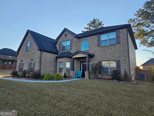 a front view of a house with a garden