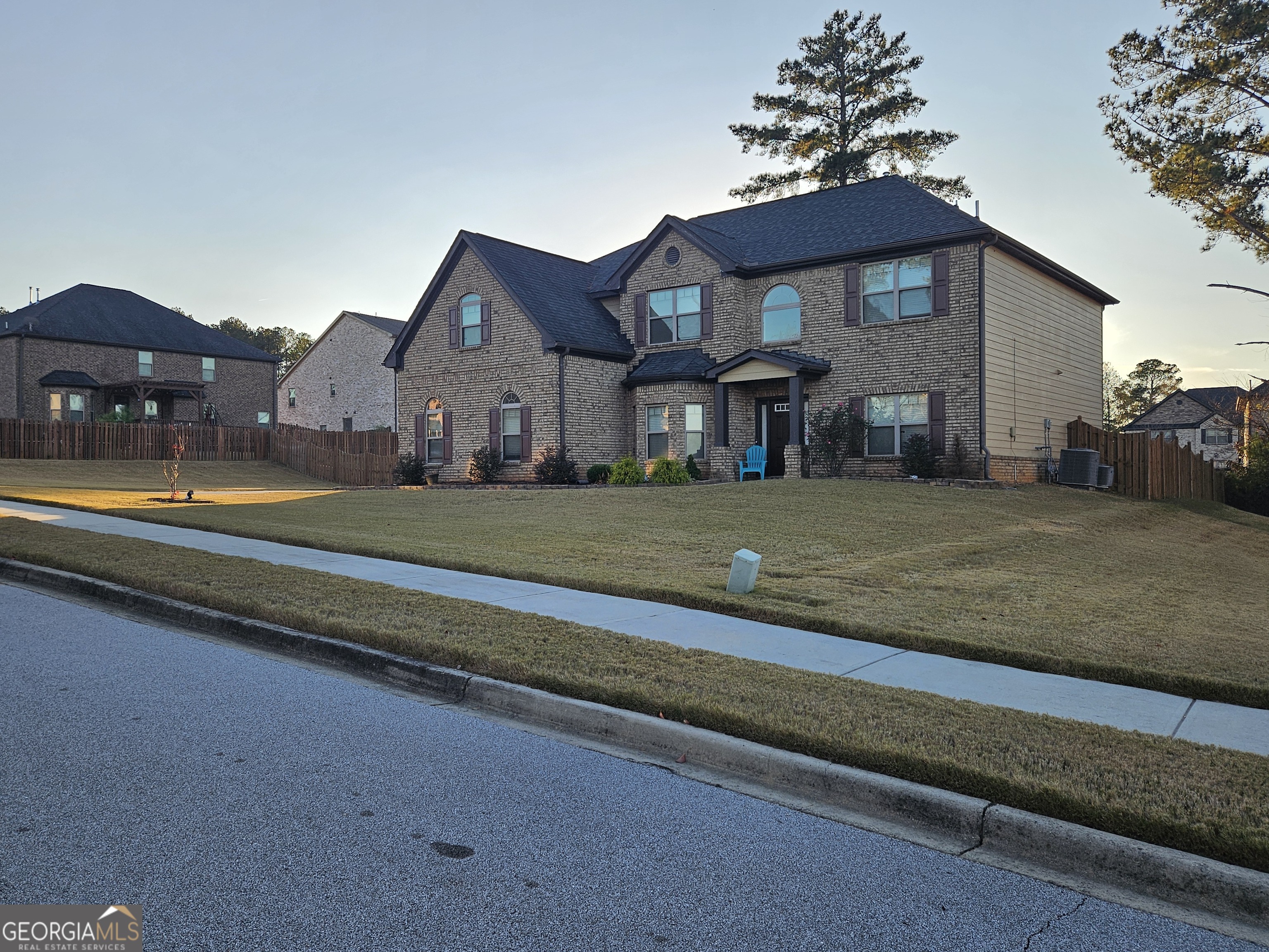 3906 Rosebay Way Southwest Conyers, GA 30094 - Photo 6 of 38 a view of a big house with a big yard and large trees