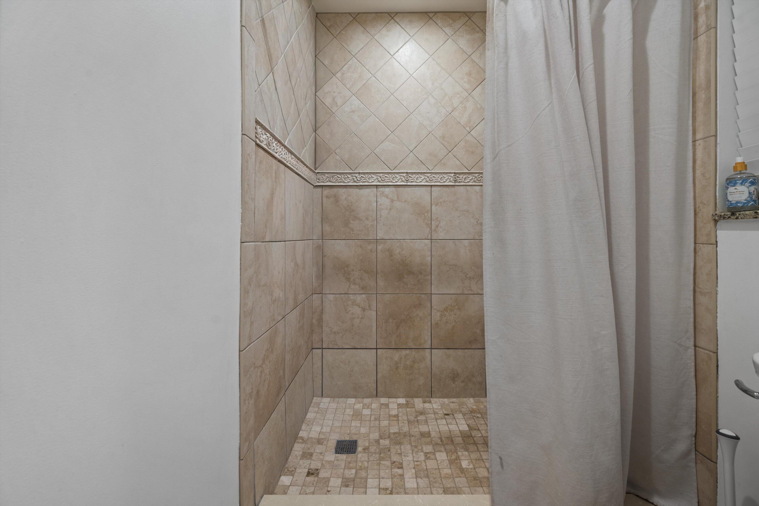 404 Pine Tree Court, Unit 6 Atlantis, FL 33462 - Photo 13 of 26 a bathroom with a shower