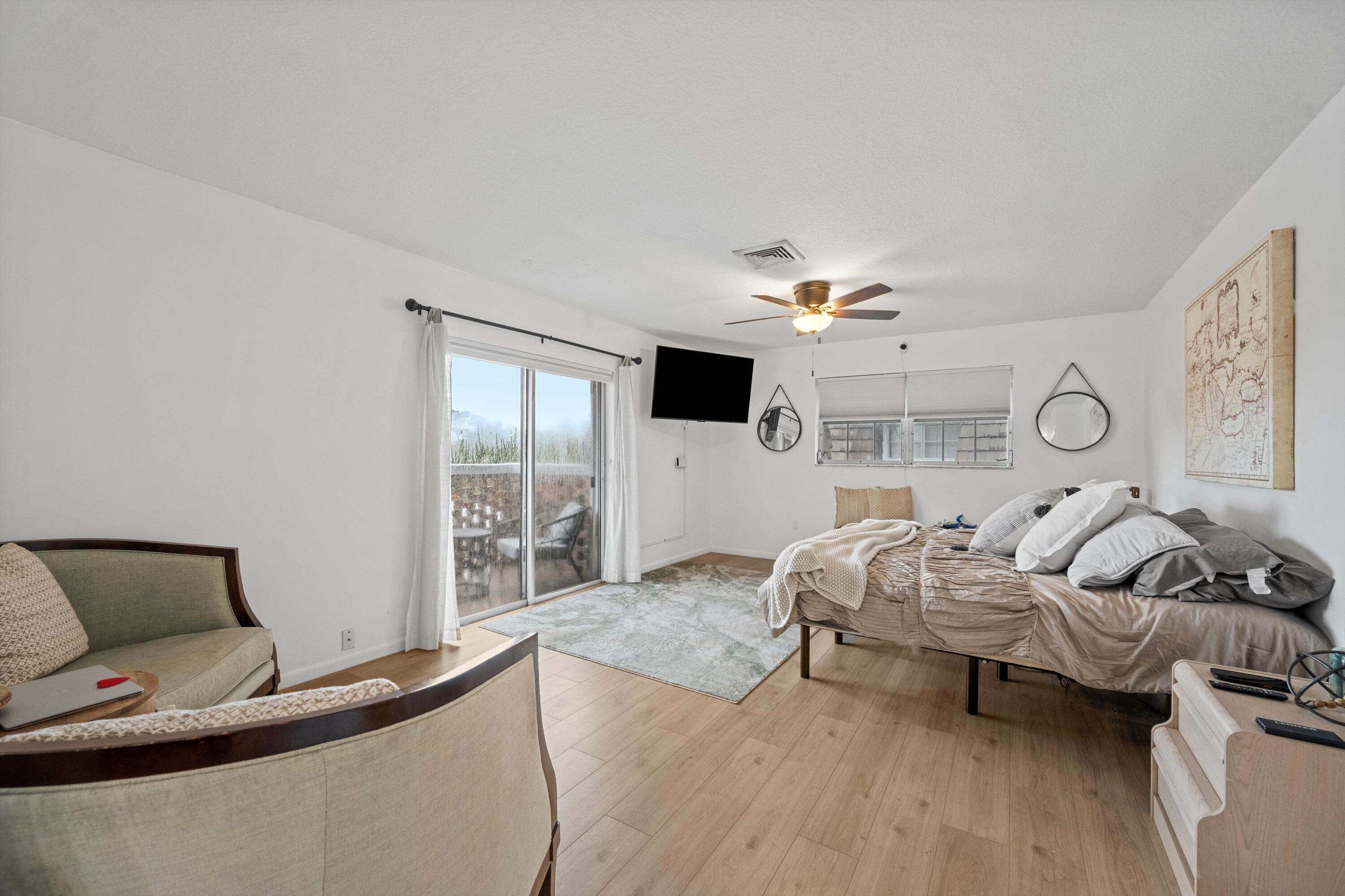 404 Pine Tree Court, Unit 6 Atlantis, FL 33462 - Photo 17 of 26 a living room with furniture and a flat screen tv