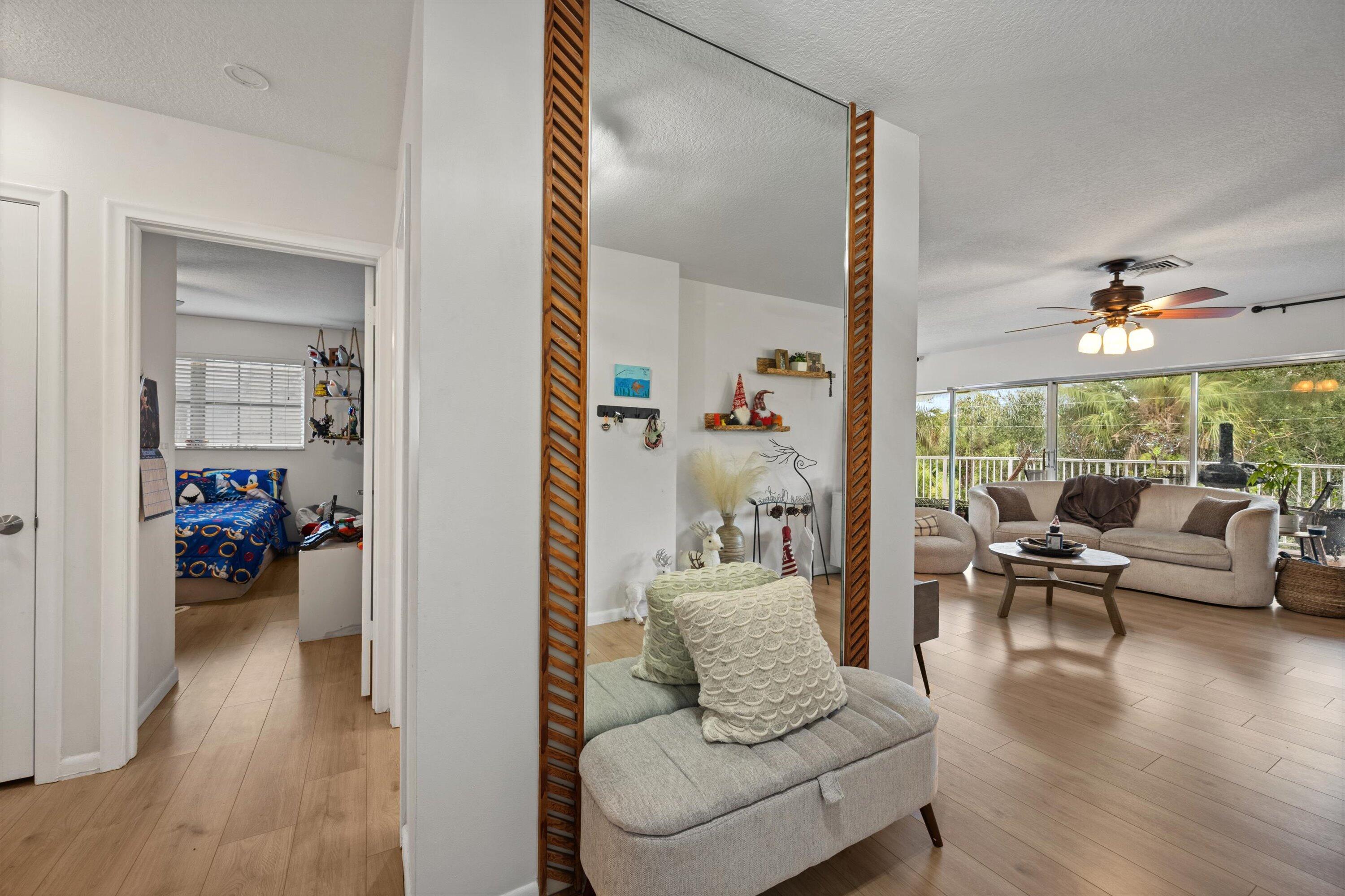 404 Pine Tree Court, Unit 6 Atlantis, FL 33462 - Photo 5 of 26 a living room with furniture and a large window