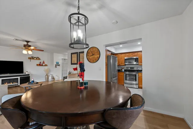a living room with dining table and chairs