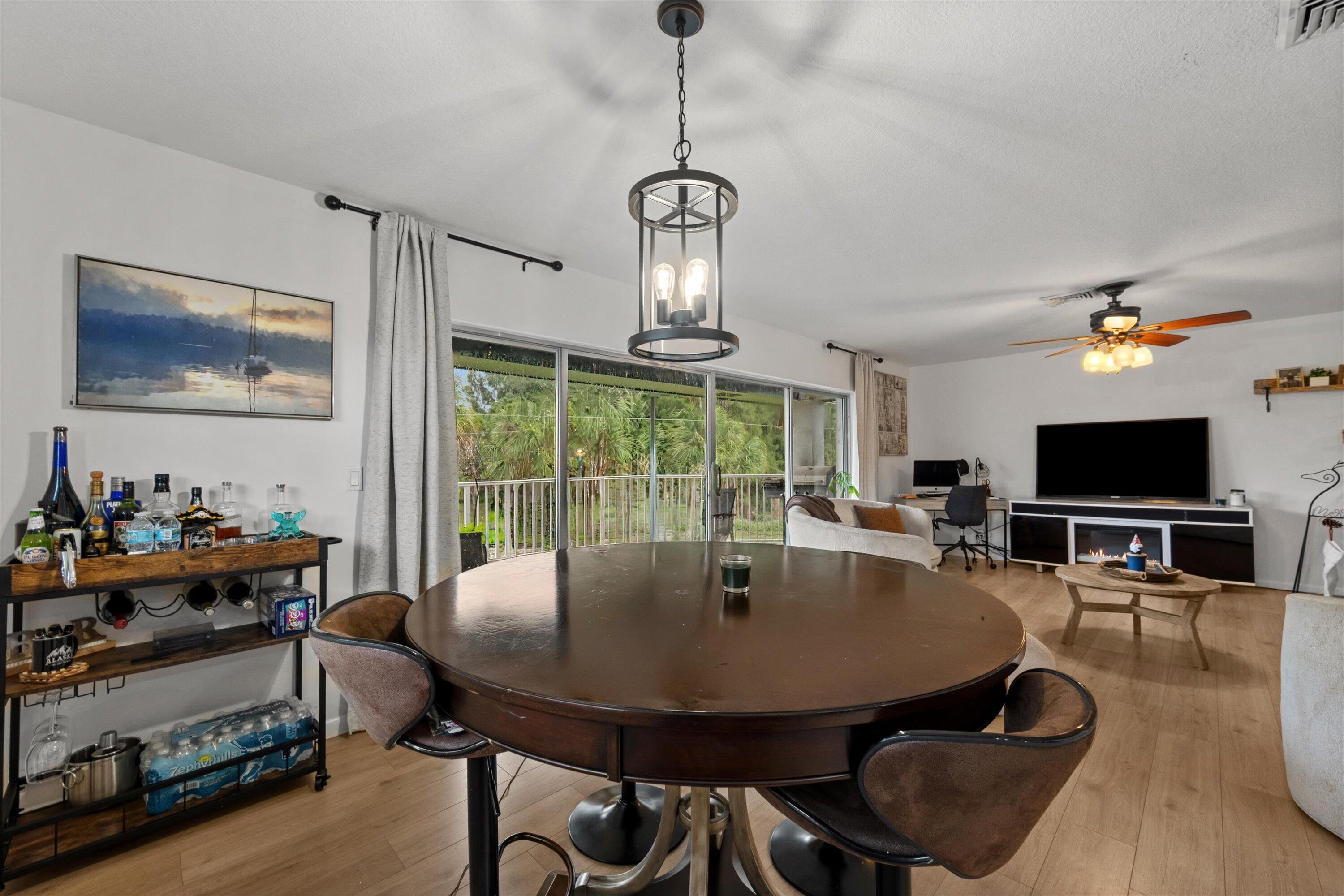 404 Pine Tree Court, Unit 6 Atlantis, FL 33462 - Photo 10 of 26 a view of a dining room with furniture window and outside view