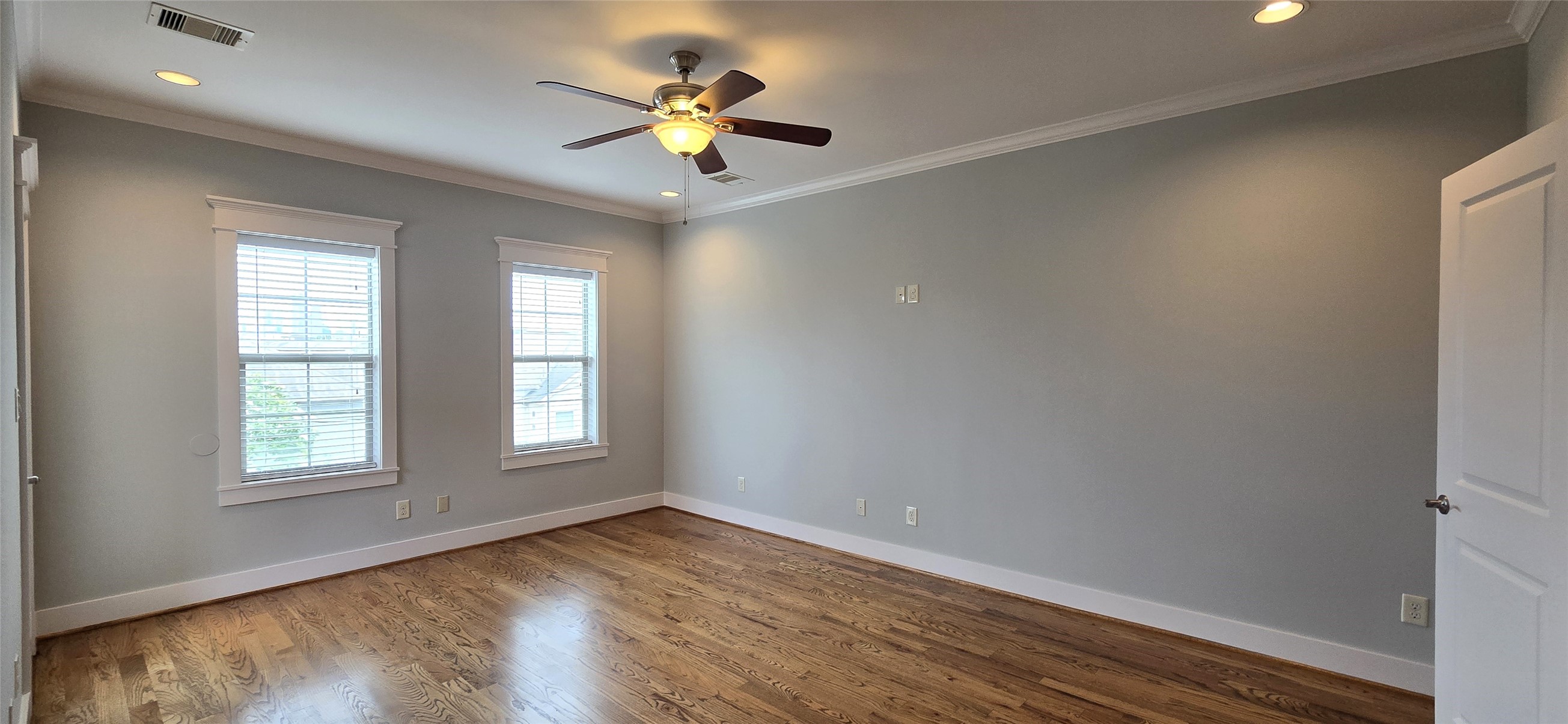 1117 Bonner Street Houston, TX 77007 - Photo 31 of 44 The primary bedroom is located on the 3rd floor and features gorgeous hardwood flooring, crown moulding, recessed lighting, a ceiling fan with light and windows allowing for more natural light.