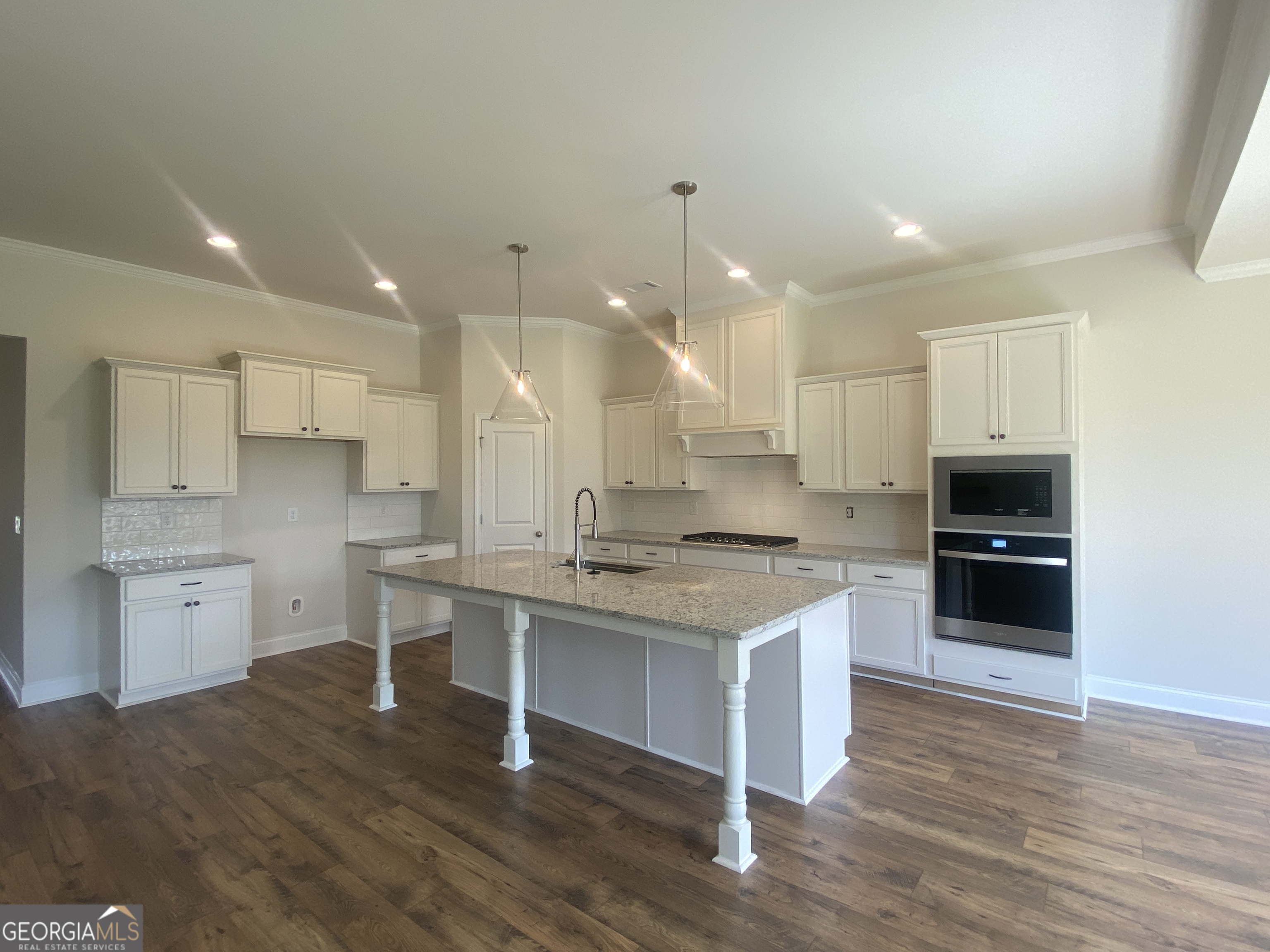 134 Oakdale Road, Unit 31 Jefferson, GA 30549 - Photo 13 of 60 a kitchen with a sink cabinets and wooden floor