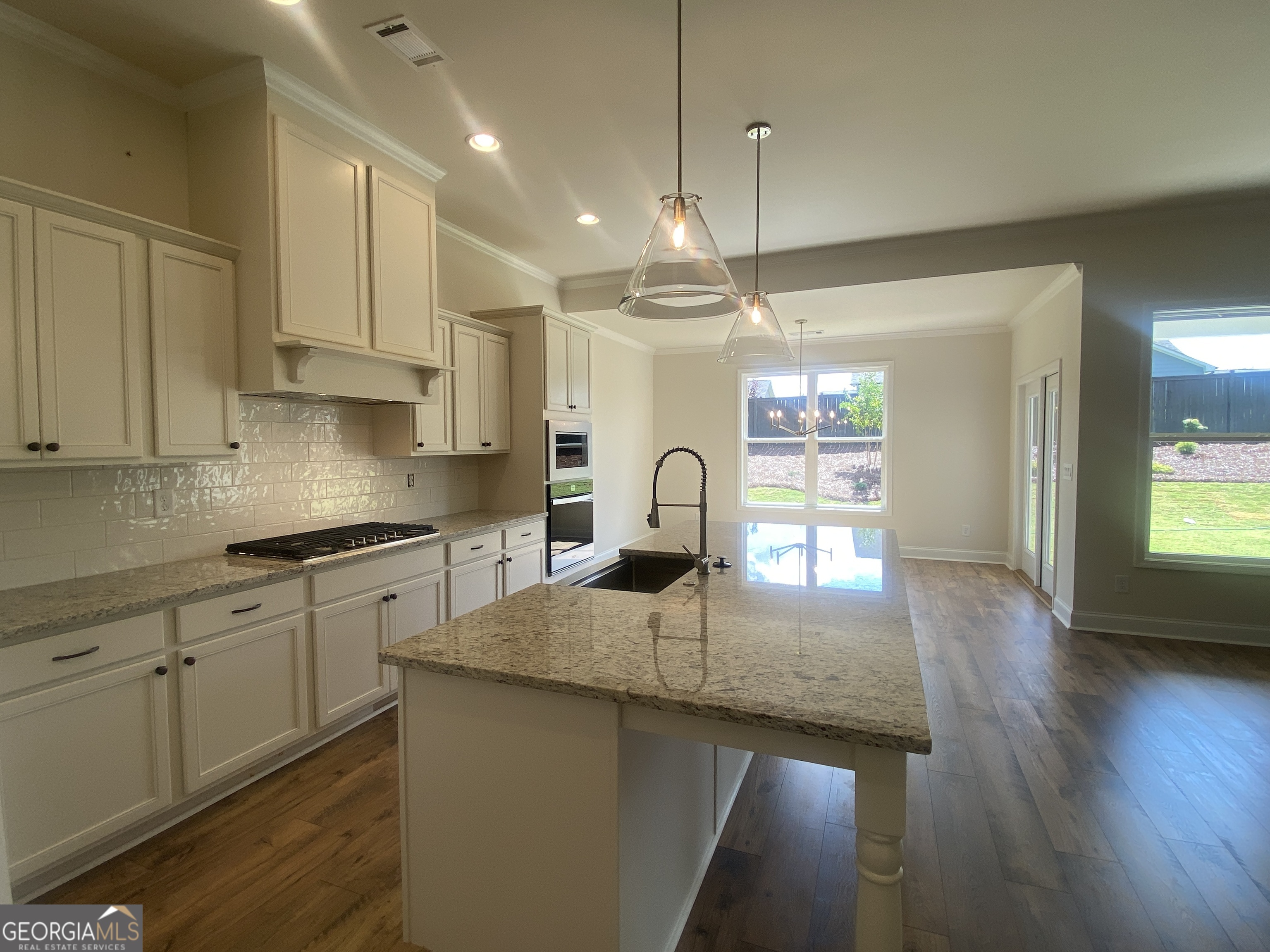 134 Oakdale Road, Unit 31 Jefferson, GA 30549 - Photo 17 of 60 a kitchen with granite countertop a sink cabinets and wooden floor