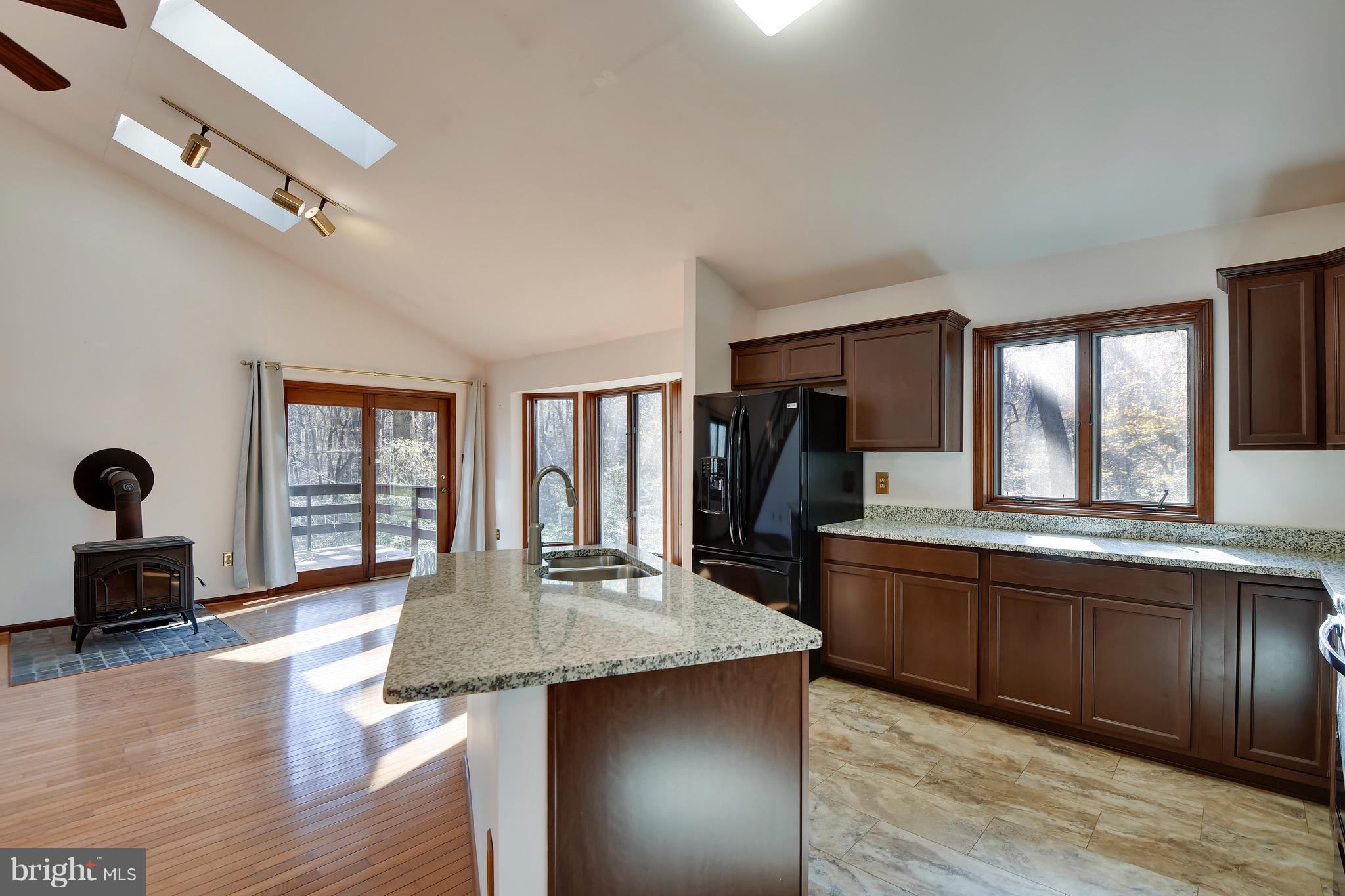 460 Farmington Road West Accokeek, MD 20607 - Photo 14 of 34 a large kitchen with stainless steel appliances granite countertop a lot of counter space and wooden floor