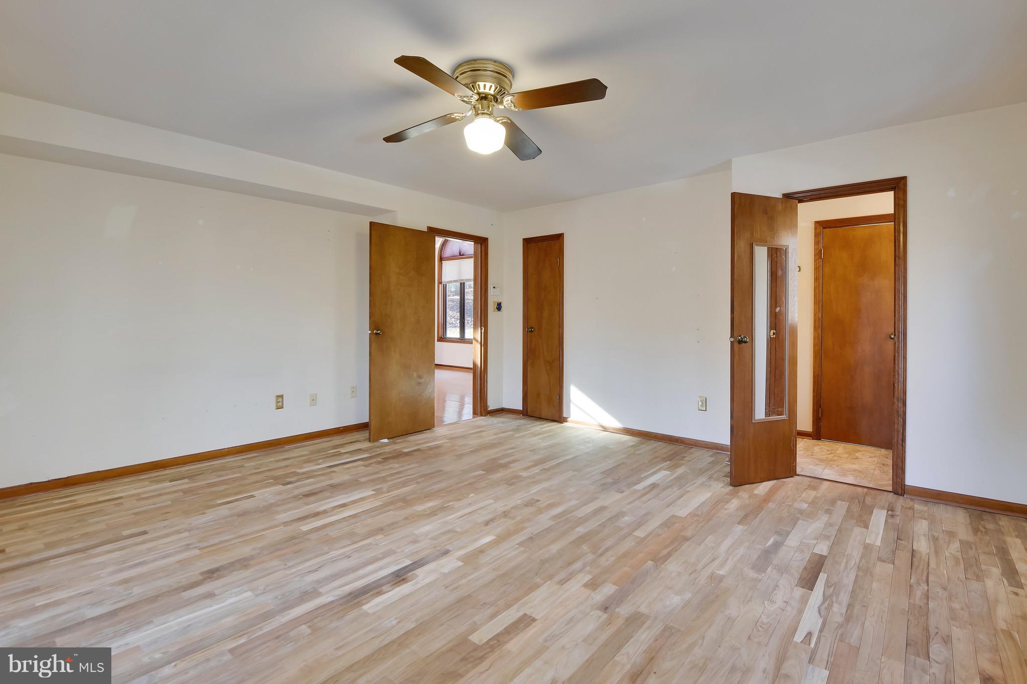 460 Farmington Road West Accokeek, MD 20607 - Photo 18 of 34 an empty room with wooden floor and ceiling fan