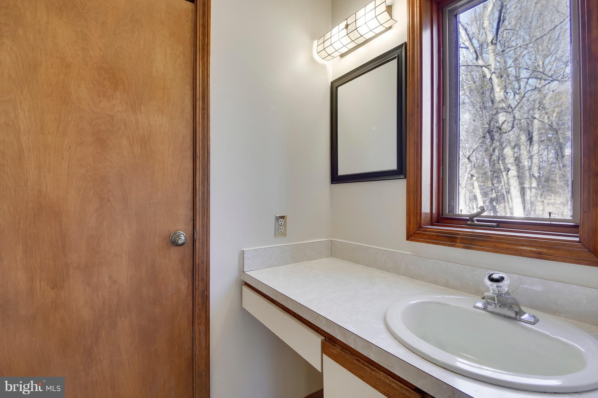 460 Farmington Road West Accokeek, MD 20607 - Photo 21 of 34 a bathroom with a sink and a mirror