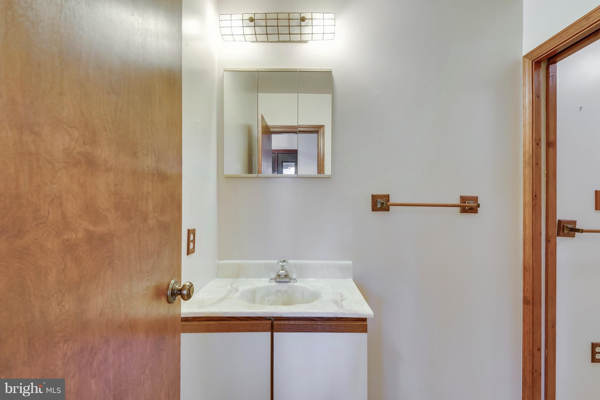 460 Farmington Road West Accokeek, MD 20607 - Photo 23 of 34 a bathroom with a granite countertop sink and a mirror