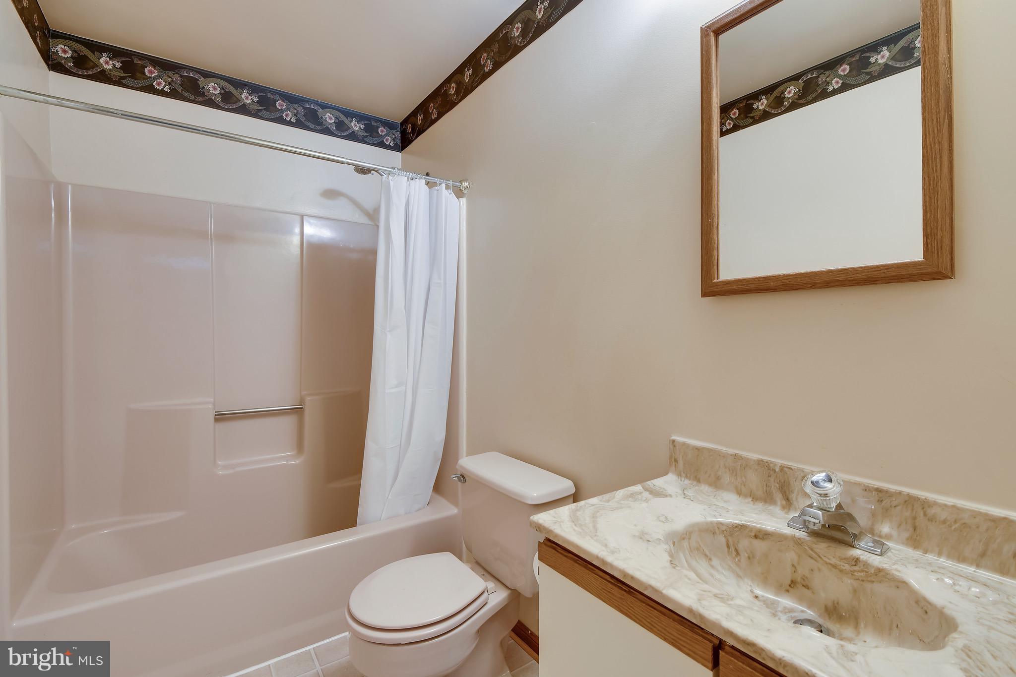 460 Farmington Road West Accokeek, MD 20607 - Photo 28 of 34 a bathroom with a granite countertop sink toilet and shower