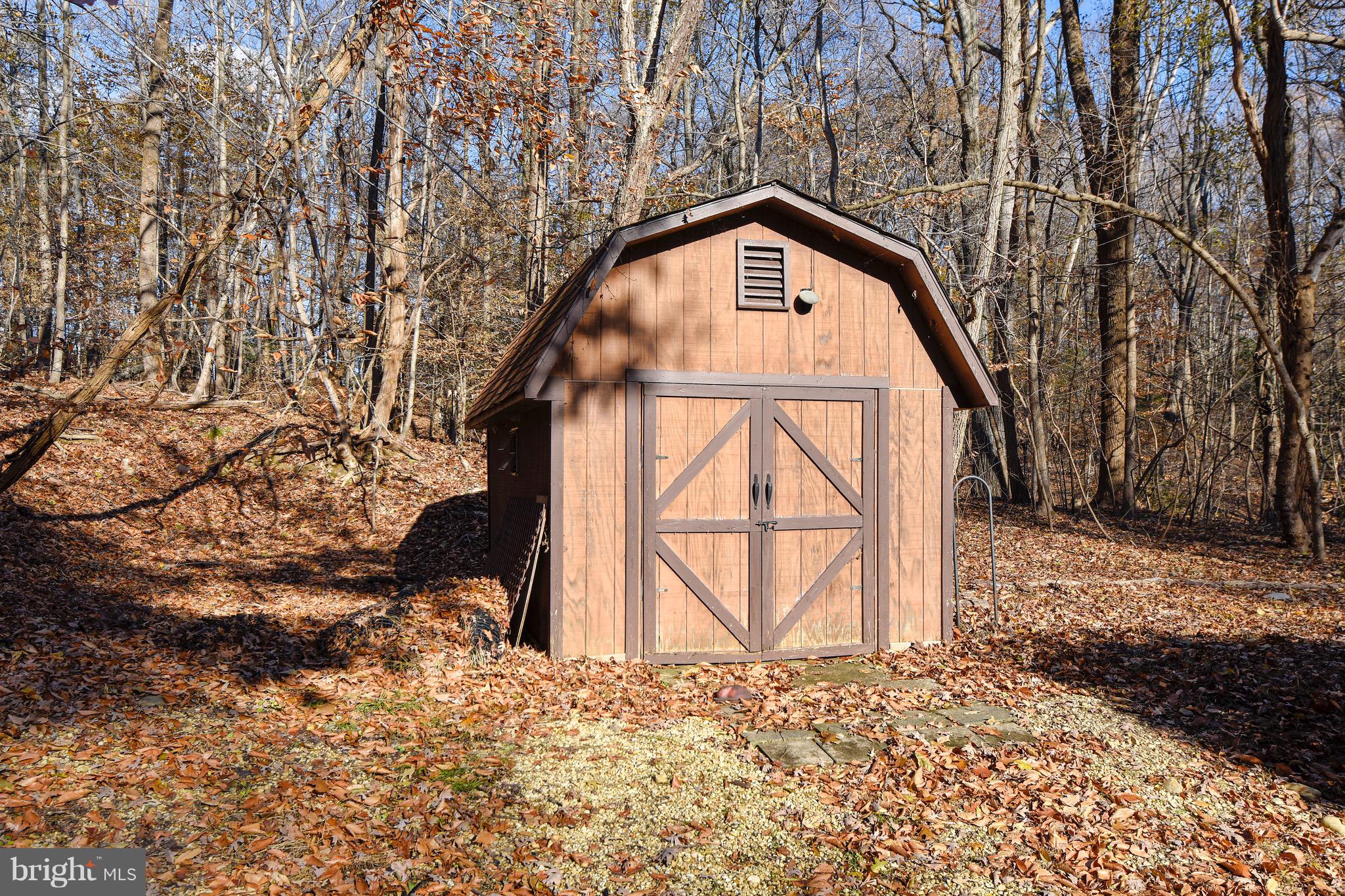 460 Farmington Road West Accokeek, MD 20607 - Photo 34 of 34 a view of a wooden house with large trees