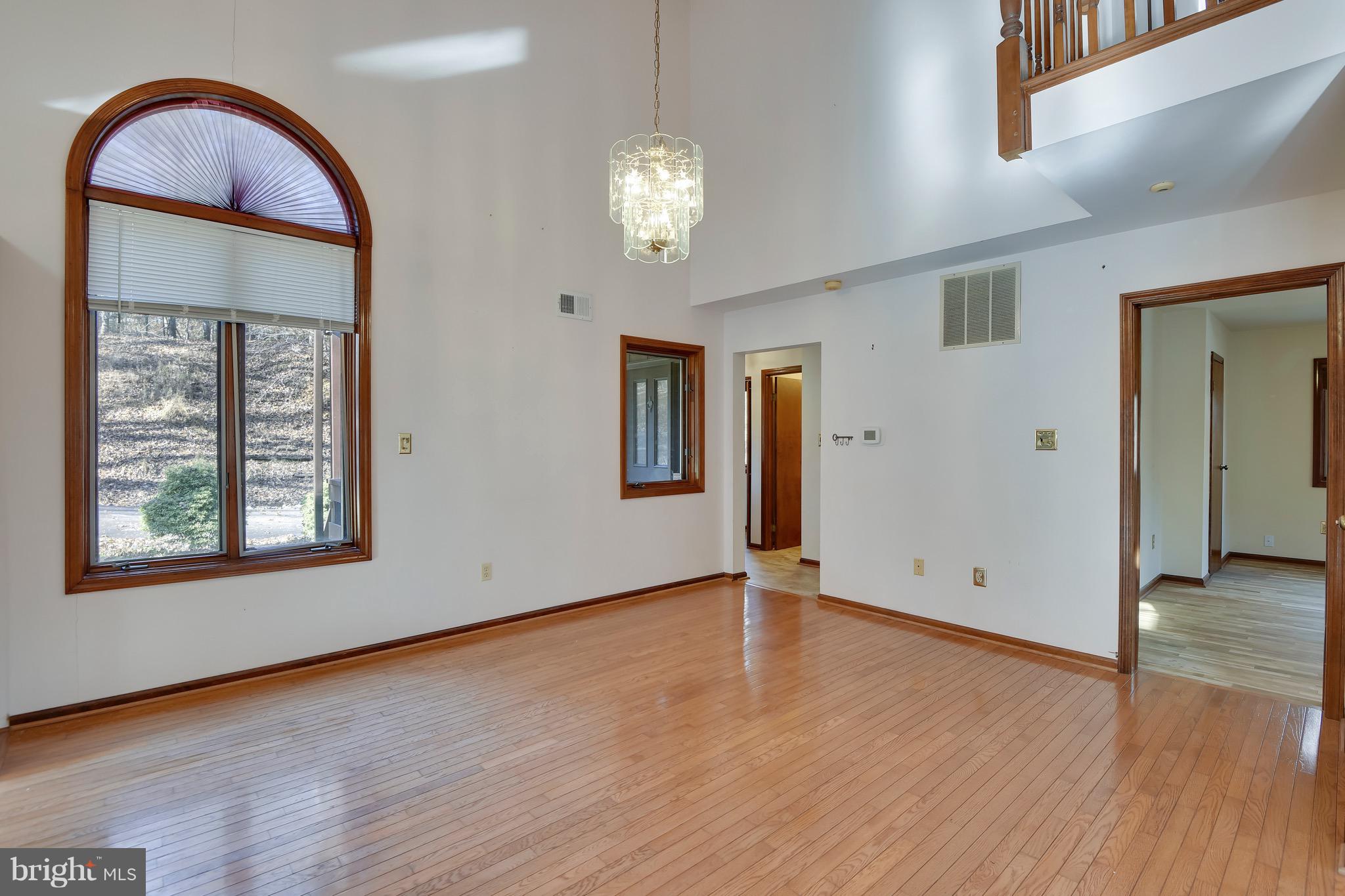 460 Farmington Road West Accokeek, MD 20607 - Photo 10 of 34 an empty room with wooden floor mirror and windows