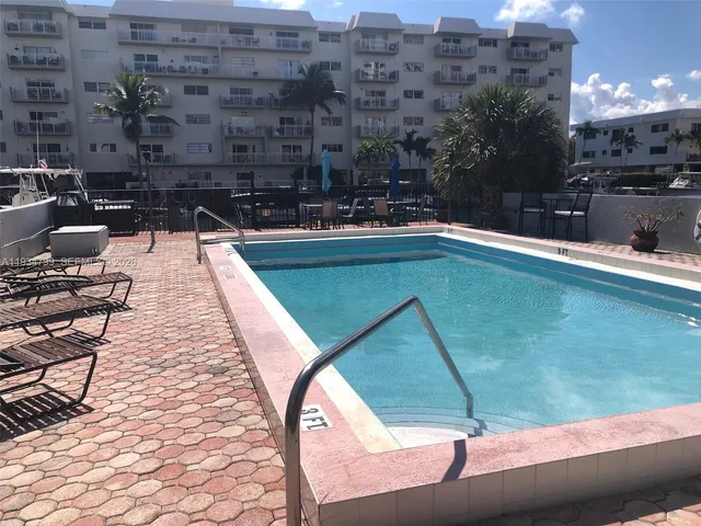 a swimming pool with outdoor seating