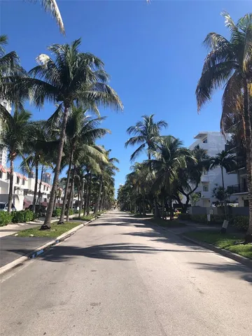 a view of street along with palm trees