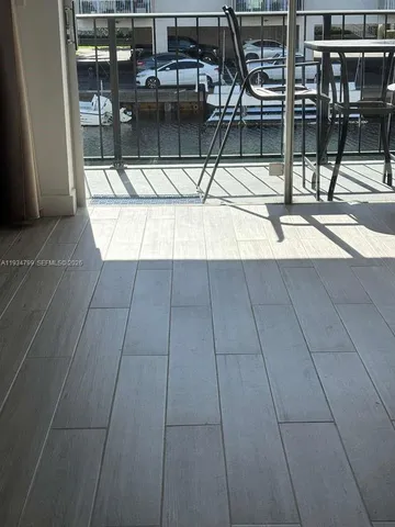 a living room with furniture and a flat screen tv with wooden floor