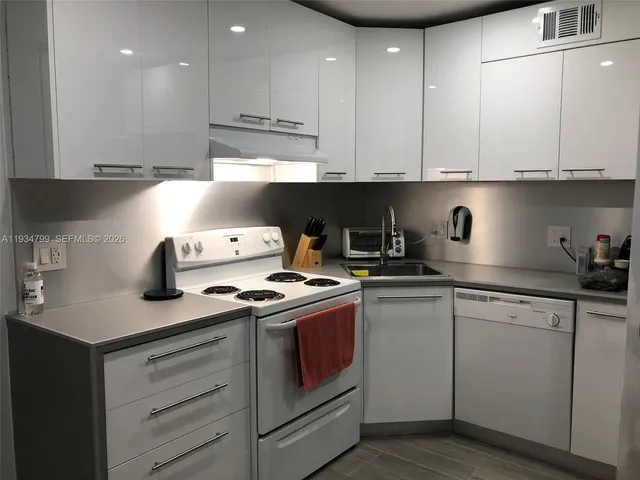 a kitchen with stainless steel appliances granite countertop a sink and a stove