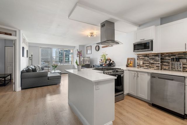 a kitchen with stainless steel appliances a sink stove and refrigerator