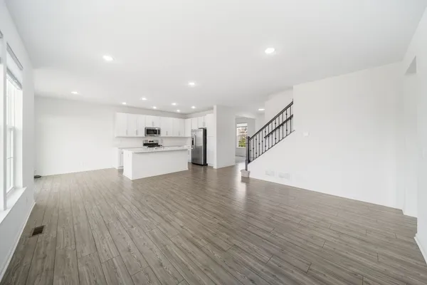 a view of kitchen with closet and wooden floor