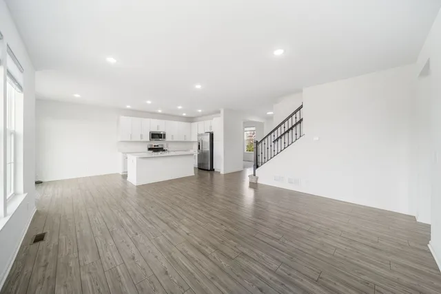 a view of kitchen with closet and wooden floor