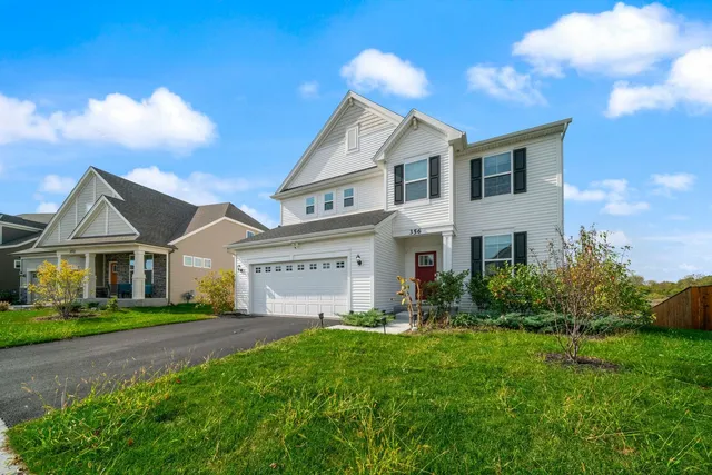 a view of house with yard and green space