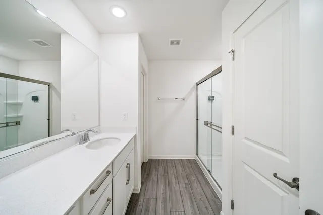 a spacious bathroom with a double vanity sink and a mirror