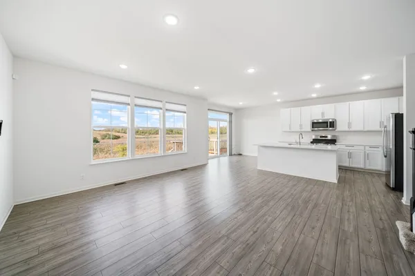 a view of kitchen with wooden floor and electronic appliances