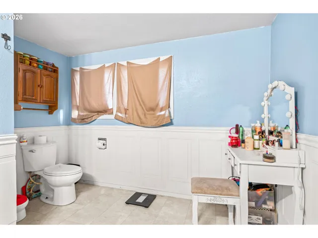 a bathroom with a sink toilet and a mirror
