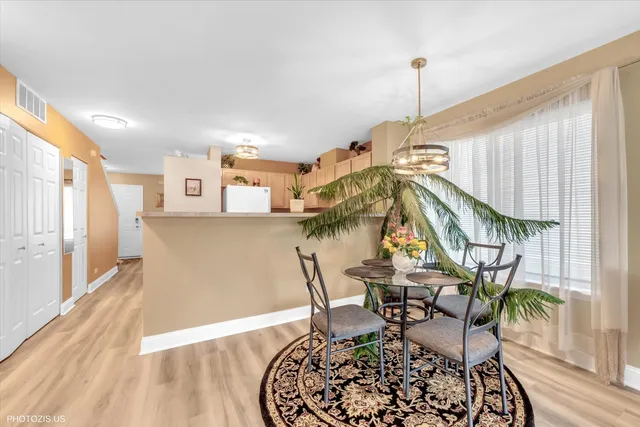 a room with lots of chairs and wooden floor