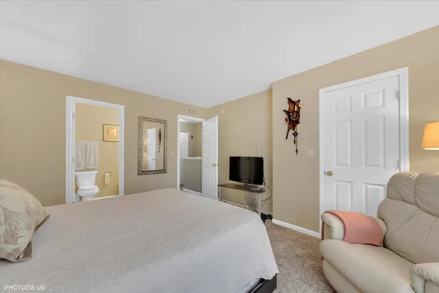 a bedroom with a bed couch and a flat screen tv