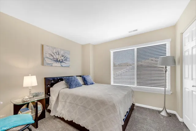 a bedroom with a bed and a night stand