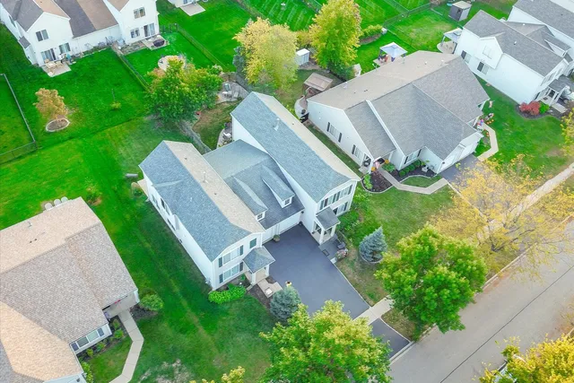 an aerial view of a house with garden space and street view
