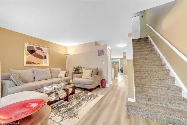 a living room with furniture and stairs