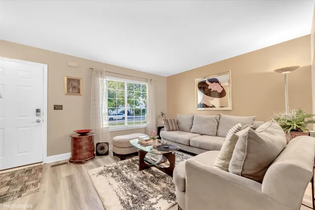 a living room with furniture a rug and a window