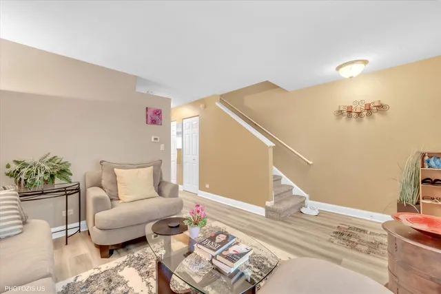 a living room with furniture and stairs