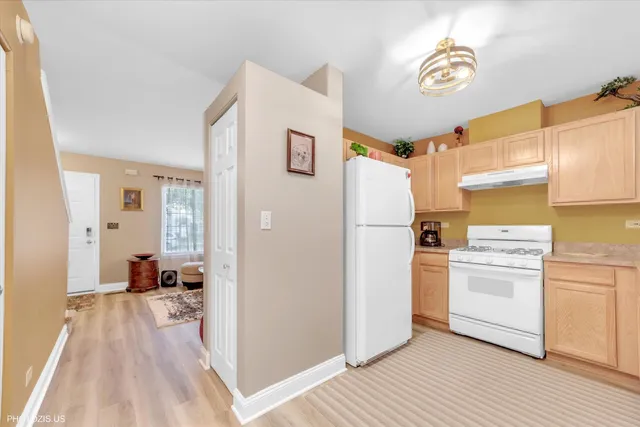 a view of a kitchen with a stove cabinets and wooden floor