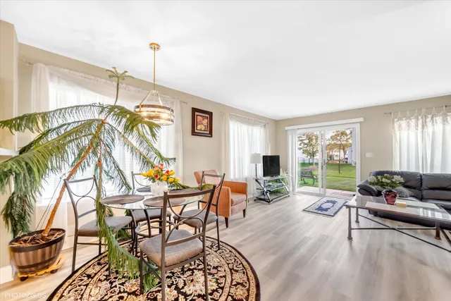 a living room with patio furniture and a floor to ceiling window