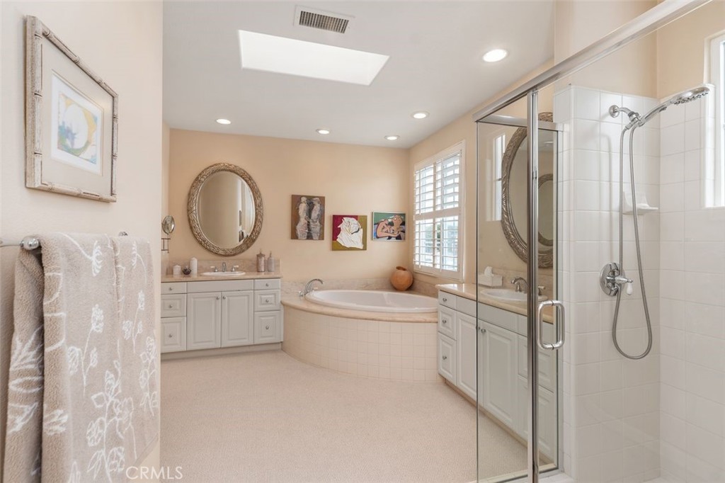 354 Salta Verde Point Long Beach, CA 90803 - Photo 15 of 33 a bathroom with a double vanity sink toilet mirror bathtub and shower
